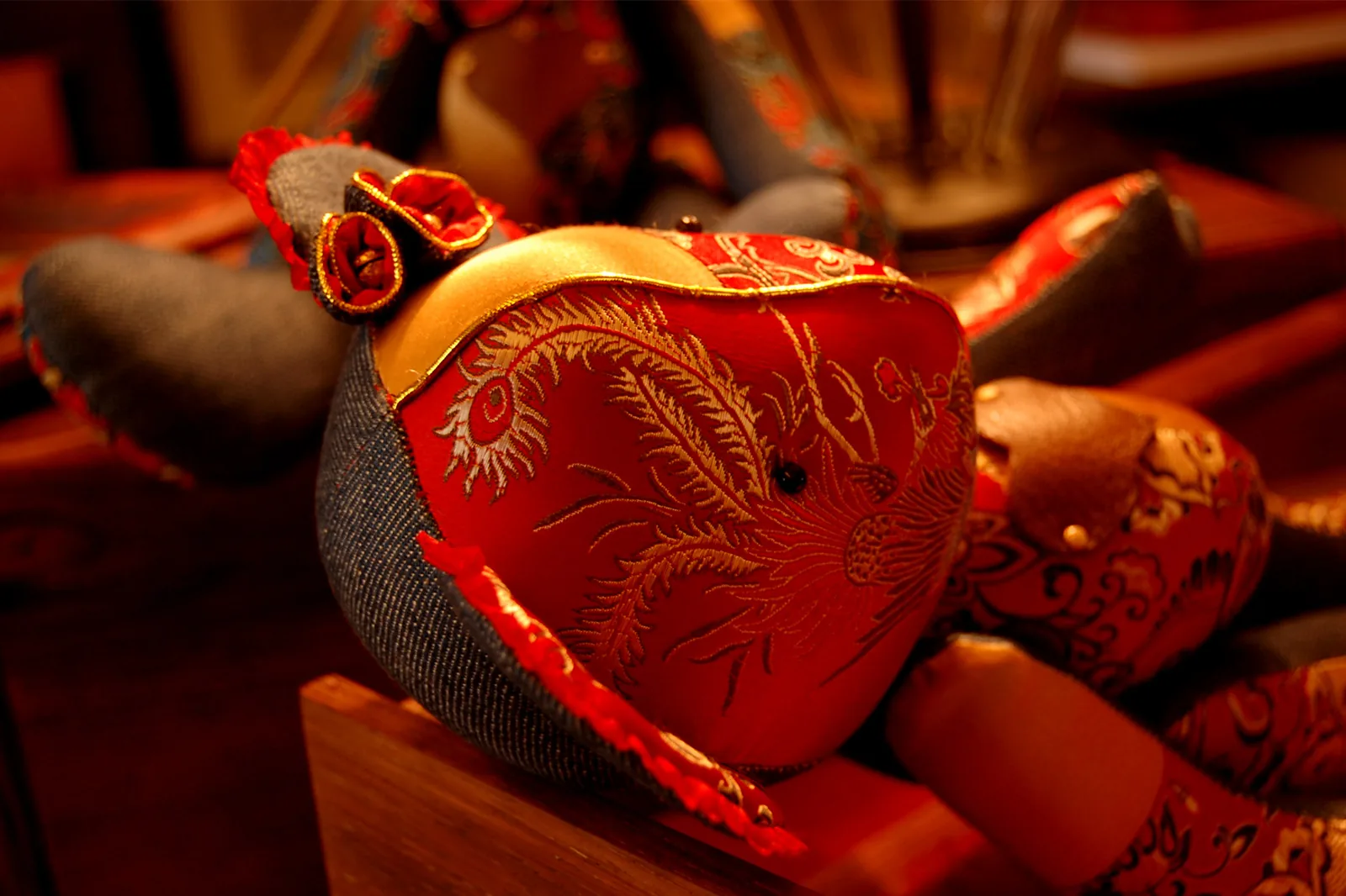 A red wedding textile detail from the archive pair